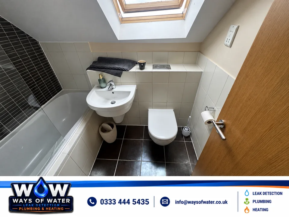 Bathroom following completion, with the toilet & flush plate refitted.